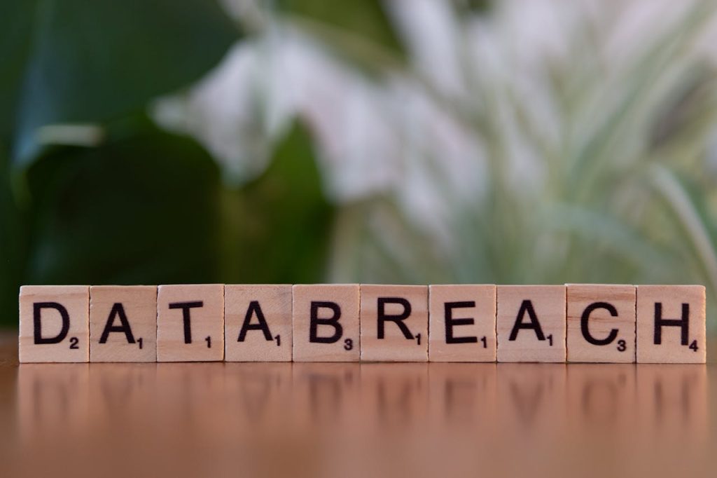 pexels photo 30901558 Close-up of Scrabble tiles spelling 'data breach' on a blurred background