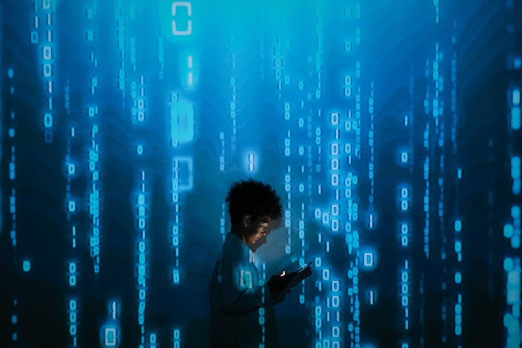 pexels photo 9783812 Silhouette of a person using a smartphone surrounded by digital binary code projections.